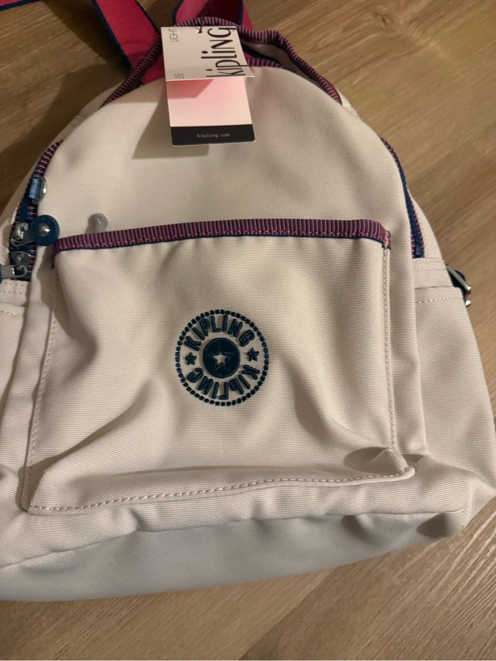 Kipling Cream Kids Backpack with Purple Trim and Blue Charm